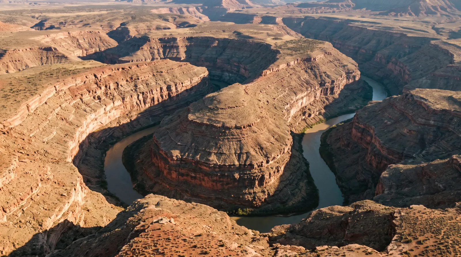 Aerial view of the San Juan River's tightly looping entrenched meanders at Goosenecks State Park in southeastern Utah, carved a thousand feet into ancient rock.